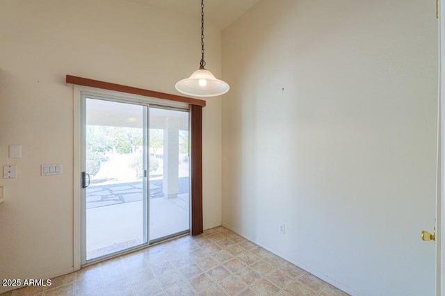 unfurnished room with vaulted ceiling