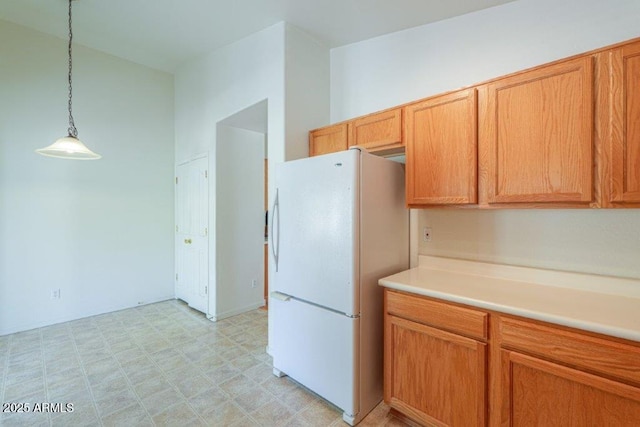 kitchen featuring decorative light fixtures and white fridge