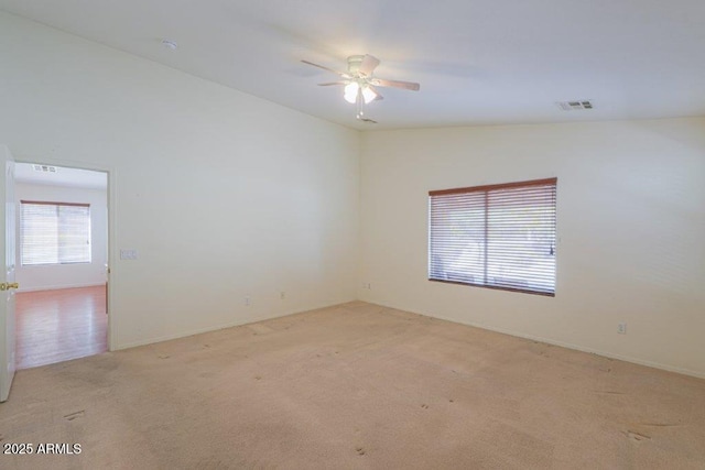 empty room featuring light carpet and ceiling fan