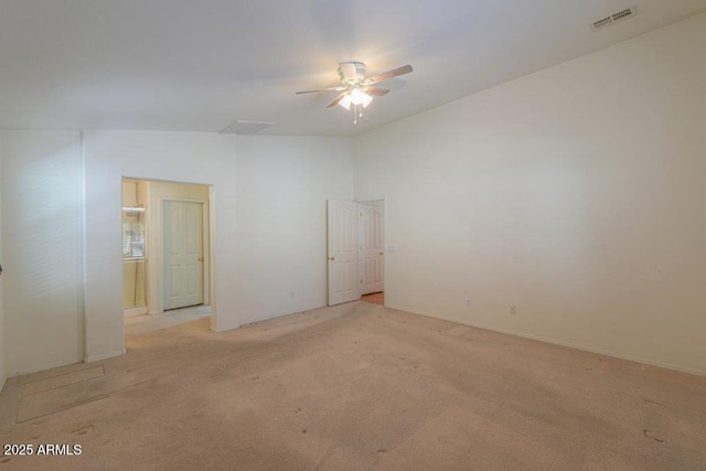 carpeted spare room featuring ceiling fan