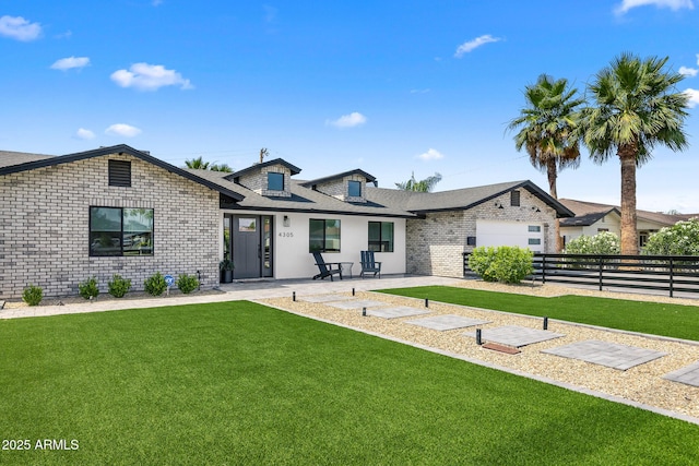 back of house featuring a garage and a yard