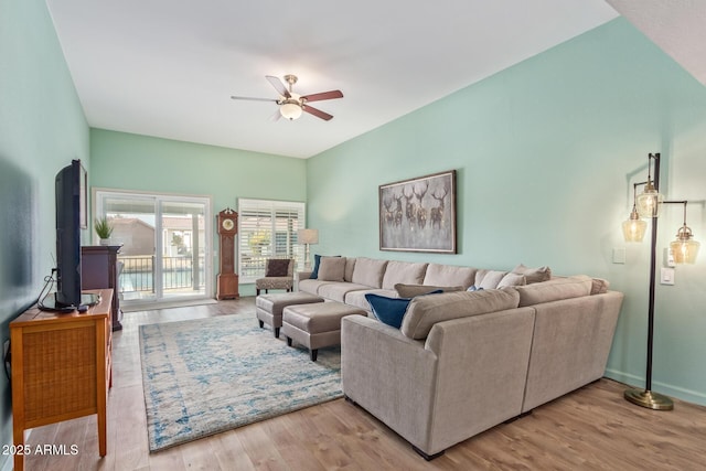 living room featuring ceiling fan and light hardwood / wood-style flooring