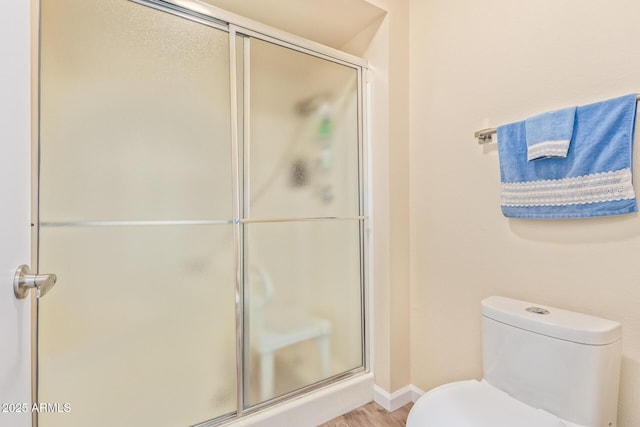 bathroom with toilet and walk in shower