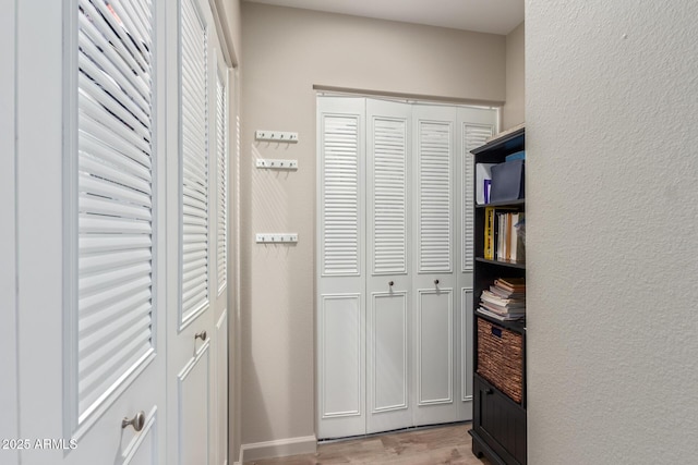 hallway with light hardwood / wood-style flooring