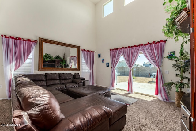 carpeted living room with a towering ceiling