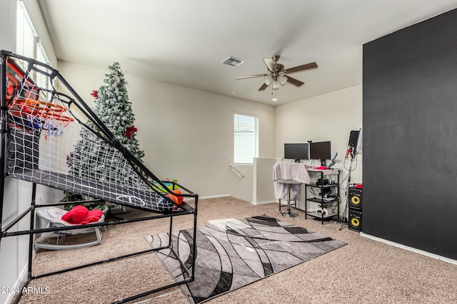 interior space featuring ceiling fan and carpet