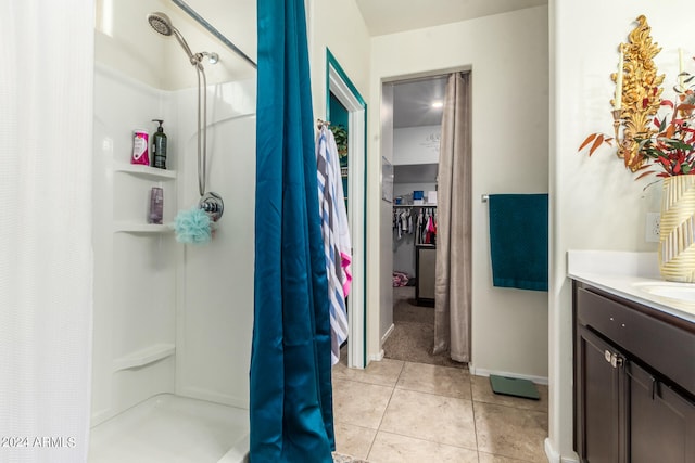 bathroom with vanity, tile patterned floors, and walk in shower