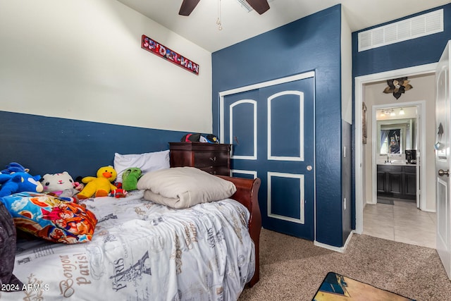 carpeted bedroom featuring a closet and ceiling fan