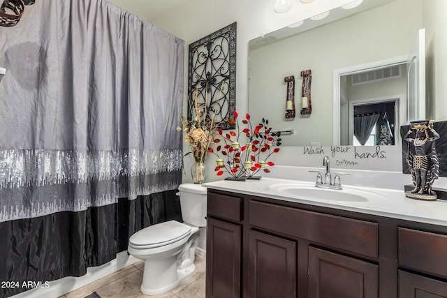 bathroom with vanity, toilet, and tile patterned floors