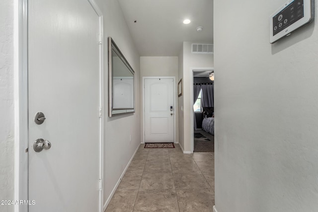 corridor featuring light tile patterned flooring