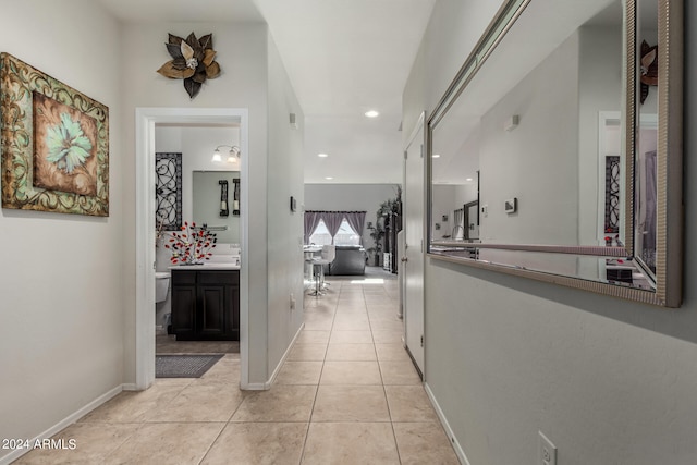 corridor featuring light tile patterned flooring