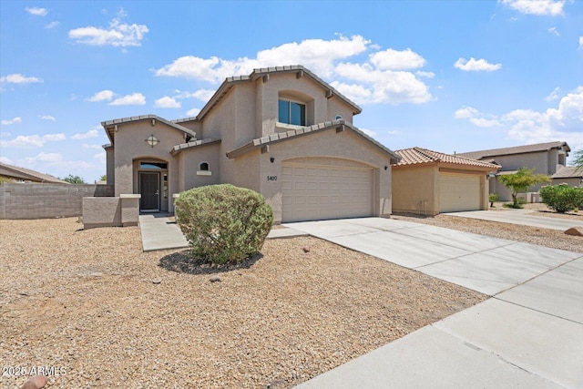 5420 W Grove St, Laveen, AZ 85339 - mediterranean / spanish home featuring stucco siding, driveway, and a garage
