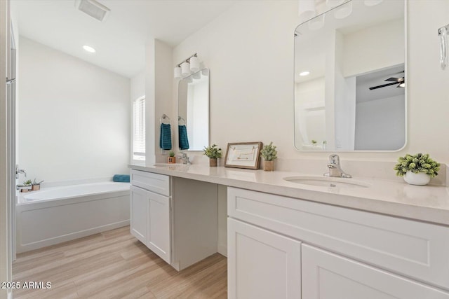 5420 W Grove St, Laveen, AZ 85339 - full bath with double vanity, a garden tub, wood finished floors, and recessed lighting