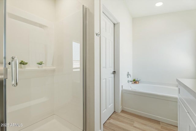 5420 W Grove St, Laveen, AZ 85339 - full bathroom featuring wood finished floors, a garden tub, a stall shower, vanity, and recessed lighting