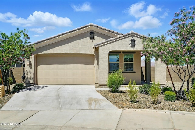 ranch-style home featuring a tile roof, a garage, fence, concrete driveway, and stucco siding