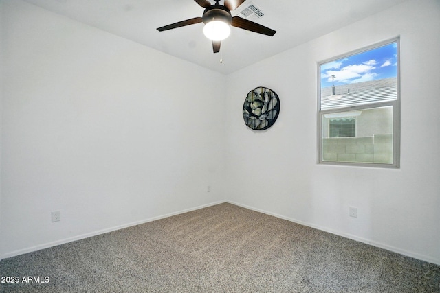 carpeted empty room featuring visible vents, a ceiling fan, and baseboards