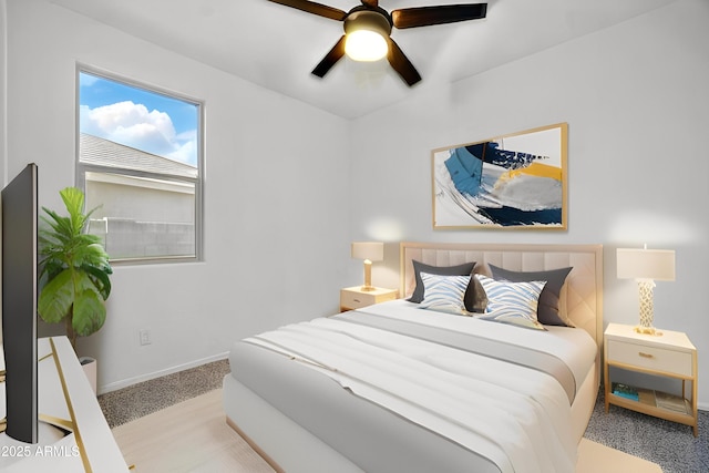 carpeted bedroom with baseboards and ceiling fan