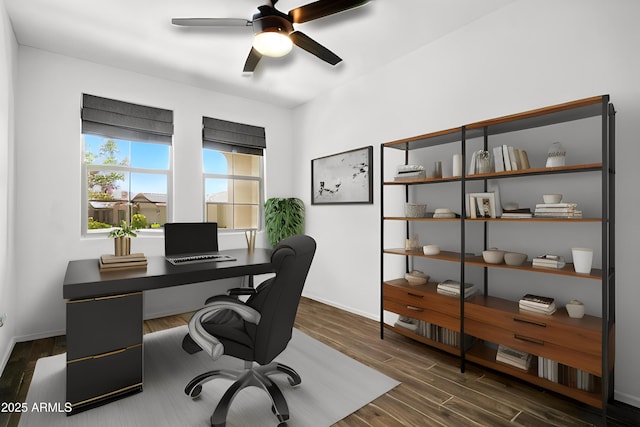 office area featuring dark wood-type flooring, a ceiling fan, and baseboards