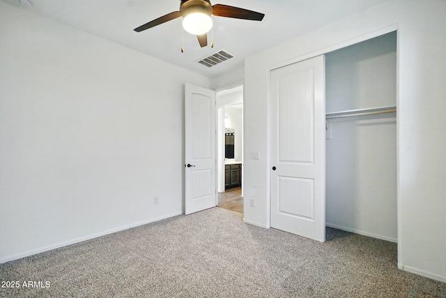 unfurnished bedroom featuring carpet floors, a ceiling fan, baseboards, visible vents, and a closet