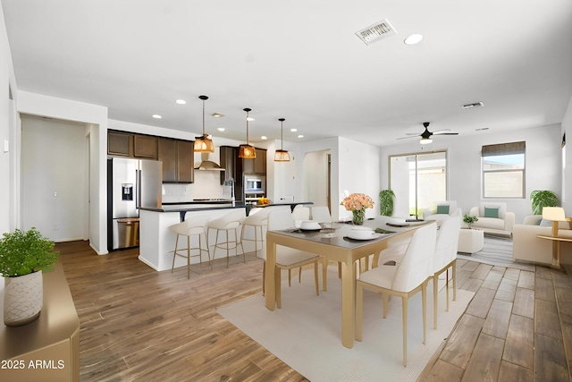 dining space featuring recessed lighting, ceiling fan, visible vents, and wood finished floors