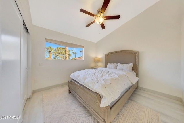 bedroom with ceiling fan, a closet, and lofted ceiling