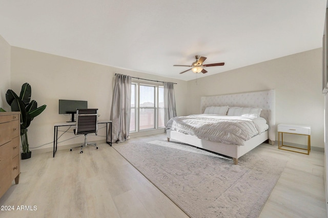 bedroom with ceiling fan and light hardwood / wood-style floors