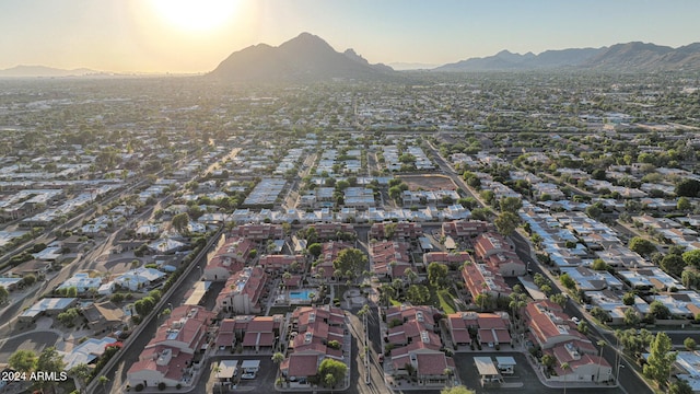 aerial view at dusk featuring a mountain view