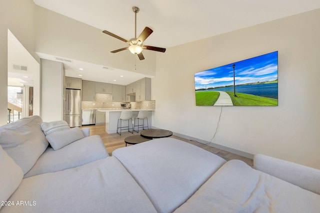 living room with ceiling fan and light wood-type flooring