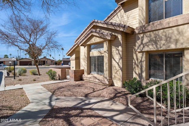 doorway to property featuring stucco siding