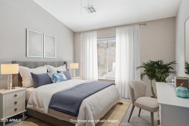 bedroom with visible vents, vaulted ceiling, and light colored carpet