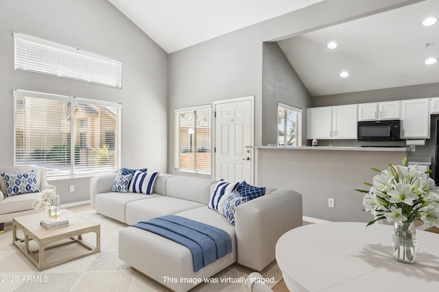 living area with baseboards, high vaulted ceiling, and recessed lighting