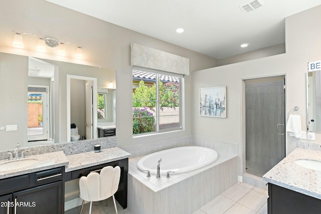 full bathroom with vanity, tile patterned floors, shower with separate bathtub, and toilet