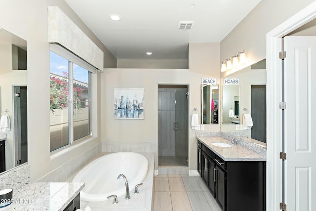 bathroom featuring vanity, plus walk in shower, and tile patterned flooring