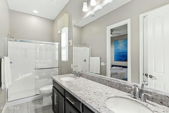 bathroom featuring walk in shower, ceiling fan, vanity, and toilet