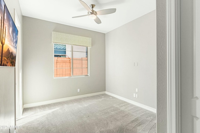 carpeted spare room with ceiling fan