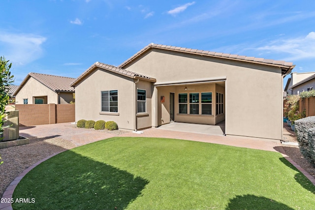 back of property with a patio and a lawn