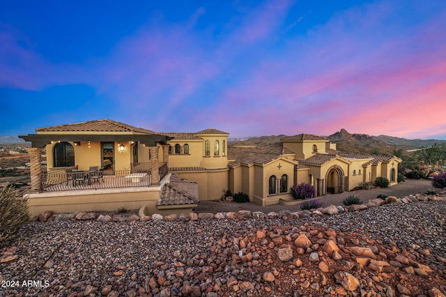 back house at dusk with a patio