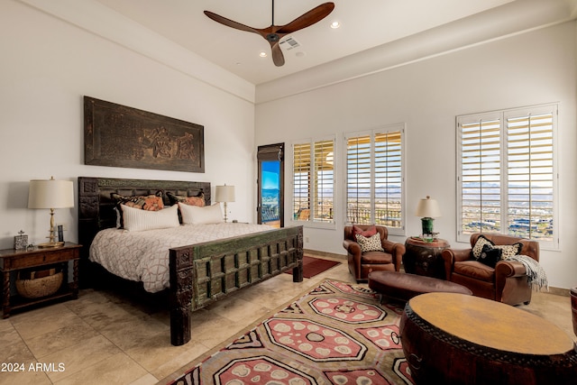 bedroom featuring a high ceiling and ceiling fan