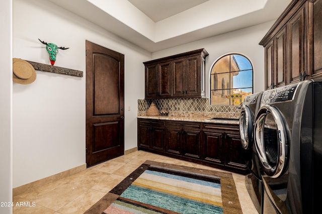 clothes washing area with cabinets, independent washer and dryer, sink, and light tile patterned floors