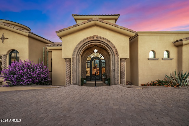 view of exterior entry at dusk