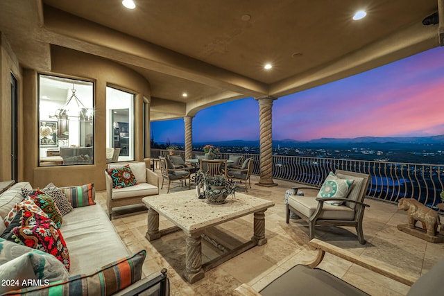 patio terrace at dusk featuring an outdoor hangout area