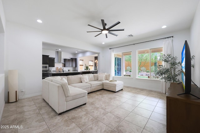 living area with recessed lighting, light tile patterned floors, baseboards, ceiling fan, and visible vents