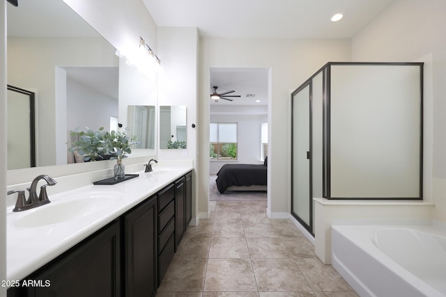full bath with a stall shower, a sink, and a ceiling fan