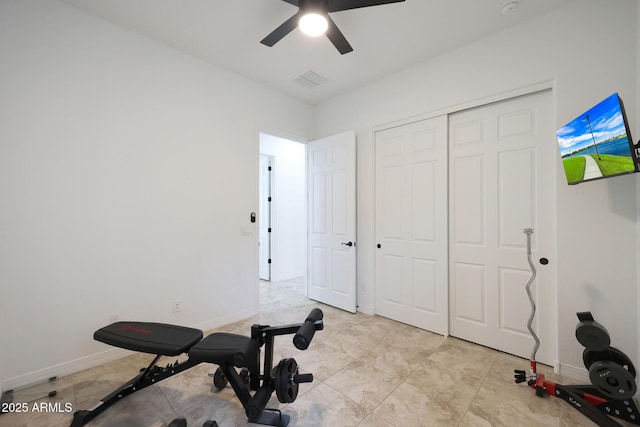 workout room featuring baseboards, ceiling fan, and visible vents