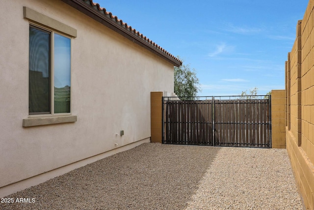 view of gate with a patio and fence