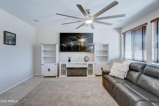 living room featuring ceiling fan and light tile patterned flooring