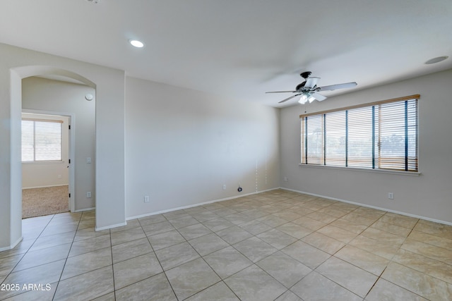 empty room featuring ceiling fan and light tile patterned floors