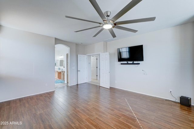 spare room featuring ceiling fan and dark wood-type flooring