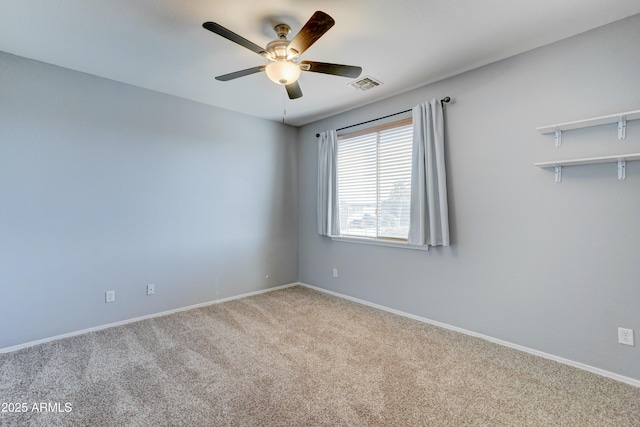 spare room with ceiling fan and light colored carpet