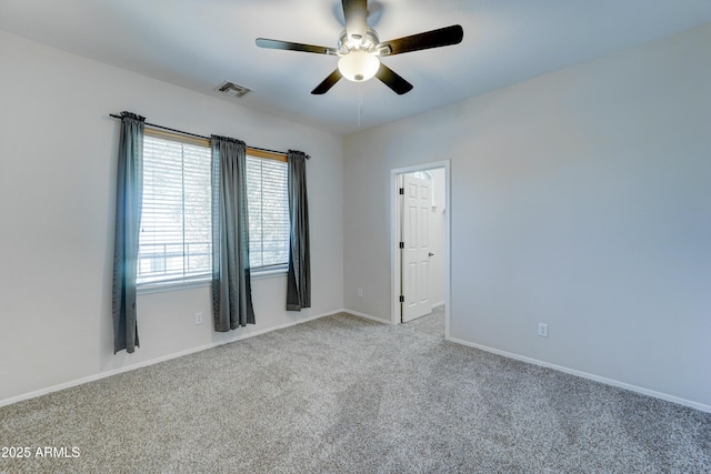 empty room with ceiling fan and light colored carpet